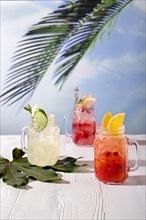 Colorful refreshing summer drinks on wooden tabletop
