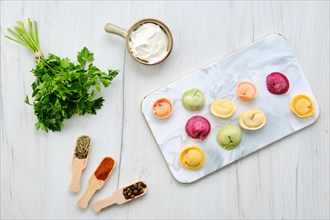 Top view of colorful meat dumplings on marble serving plate
