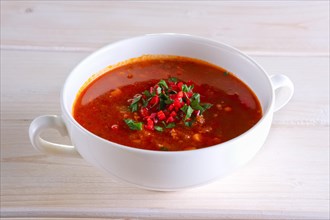 Plate of gazpacho on wooden table
