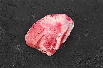 Raw fresh pork leg joint meat on black background