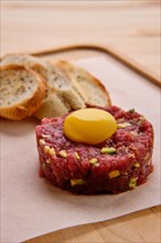 Classic steak tartare with egg and garlic bread
