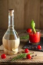 Rustic cocktail Bloody Mary with ingredient on wooden table