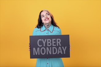Beautiful woman holding a Cyber Monday sign. Commercial concept. Commerce