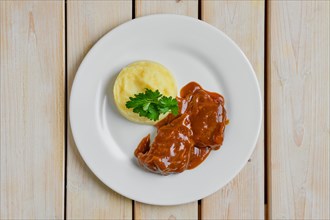 Top view of baked beef fillet with flour sauce with mashed potato