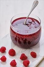 Close up view of transparent pot with raspberry jam