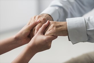 Nurse holding senior man s hands sympathy