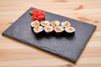 Rolls with salmon and avocado on slate plate