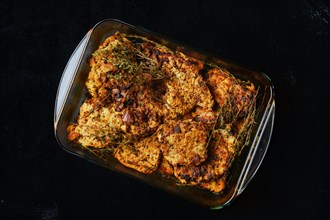 Pork chop fillet baked in oven with seasoning and herbs