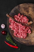 Top view of fresh beef minced meat on wooden chopping stump