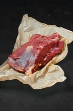 Raw fresh beef neck on wrapping paper