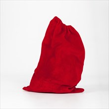 Red sack gifts standing white background