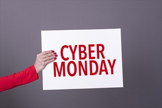 Female hand holding a cyber monday poster. Commercial concept