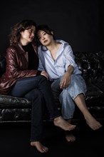 Two Asian woman on couch