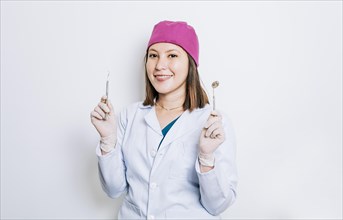 Portrait of a dentist woman holding dental tools