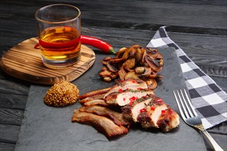 Fried pork fillet with mushrooms and slices of bacon served with pepper moonshine. Unhealthy but so tasty country food