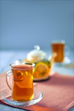 Selective focus photo of citrus tea with lemon
