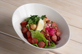 Salad with smoked sausage and egg