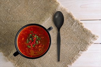 Top view of plate of gazpacho on wooden table