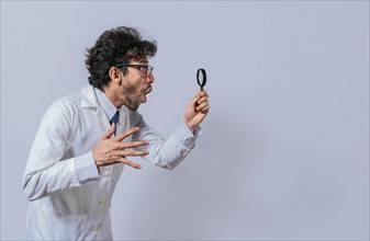 Scientist holding a magnifying glass looking to the side