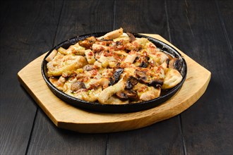 Slices of eggplant baked with champignon and cheese in cast iron skillet