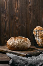Artisan whole grain tomato wheat bread on wooden table