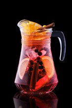 Pitcher with cold sangria isolated on black background