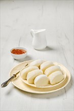 Closeup view of semifinished frozen lazy dumplings made of curd on a plate