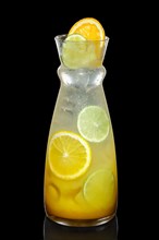 Cold Lemon cocktail with a sparkling wine with ice cubes in pot isolated on black