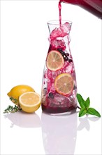 Pouring in jug with ice black currant drink