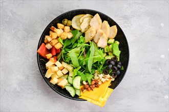 Top view of bowl with salad mix and various snacks as a starter
