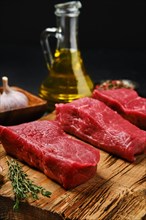 Closeup view of raw boneless strip steak loin with spice on cutting board