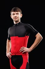 Sport. Cyclist in training clothes on black background
