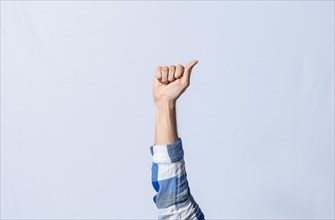 Hand gesturing the letter A in sign language on isolated background. Man hand gesturing the letter A of the alphabet isolated. Letters of the alphabet in sign language