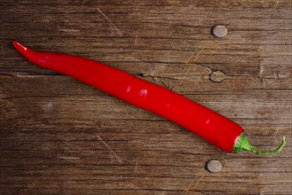Top view of chili pepper on wooden background