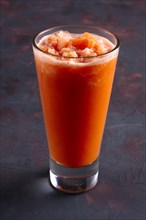 Glass of carrot granizado. Crushed ice with fruit syrup beverage
