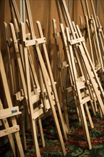 Dozens of of wooden easels in a room