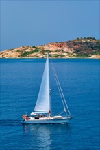 Yacht boat in blue waters of Aegean sea near Milos island