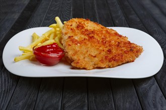Fried chopped pork cutlet with potato balls and creamy sauce with mushroom and onion