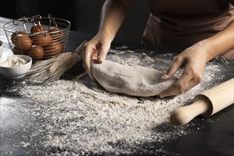 Chef preparing dough with rolling pin flour