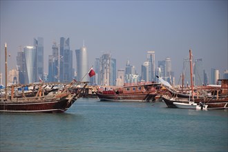 Fishing boats in front of the skyline of Doha