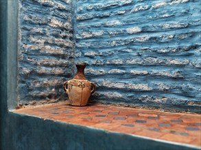 Decorative jug in a wall niche