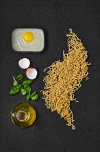 Top view of composition with homemade noodles on kitchen table