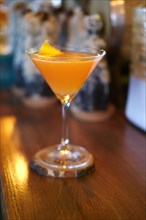 Soft focus photo of Brown Derby Cocktail. Image with shallow depth of field and contains a little noise due to poor lighting conditions