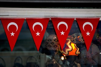 Triangle shaped Turkish national flags are attached to a rope