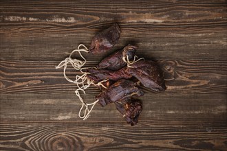 Overhead view of dried jerked deer or venison meat on wooden background