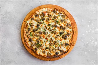 Thin-crust pizza dough with mushrooms and lot of melted cheese