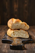 Fresh loaf of wheat bread on wooden cutting board