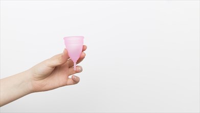 Close up hand holding menstrual cup