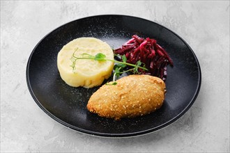 Kiev citlet with mashed potato and pickled beetroot on a plate