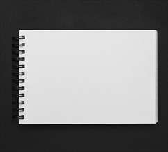 Elevated view spiral notepad black background